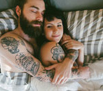 guy with beard in bed with girl