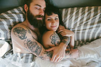 guy with beard in bed with girl