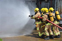 fire fighters walking towards fire