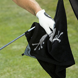 golfer drying his golf club with a towel