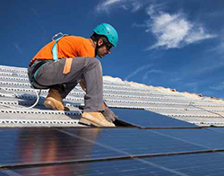 guy working on roof with good traction soles under his boots