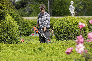 mowing the lawn with the better landscaping boots