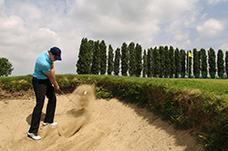 hitting the ball with a sand wedge