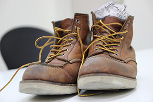 wet work boots drying with stuffed paper