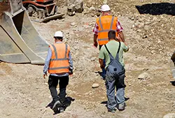 workers walking on construction site wearing safety footwear