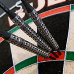 dartboard with steel tip darts thrown in